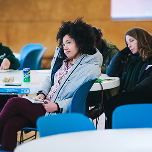 Young people listen to a workshop at a round table