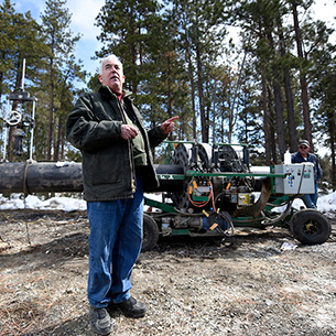 Person gestures to logging machinery