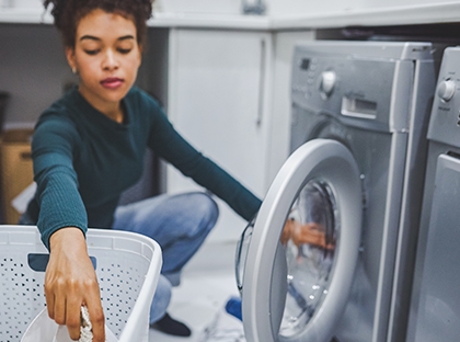 woman loading dryer