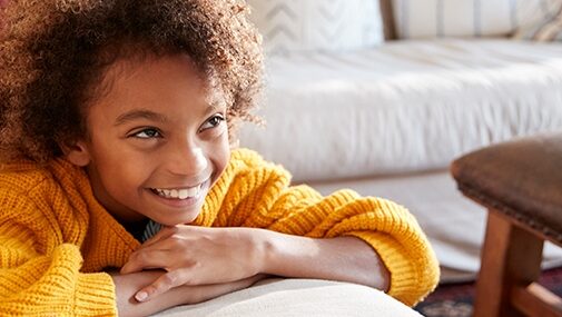 Smiling girl in yellow sweater