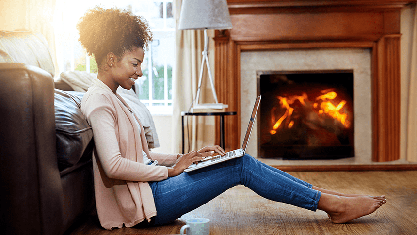 a woman sitting in front of a fireplace