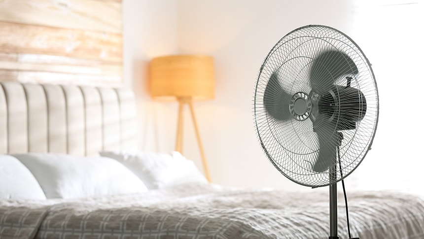 a fan in a bedroom