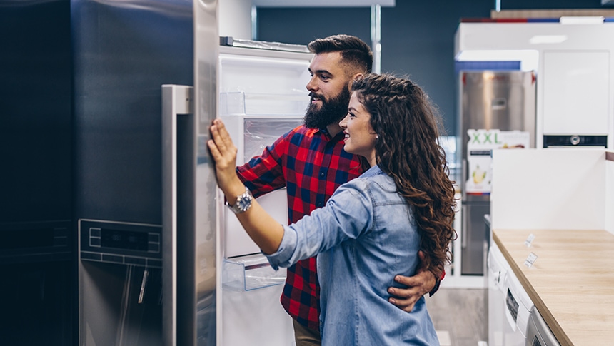 Couple shopping for refrigerators