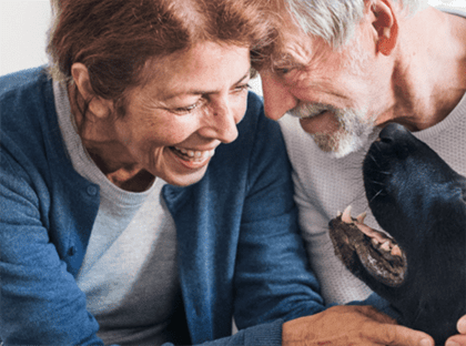 Couple playing with dog