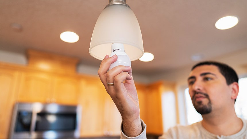 man installing lightbulb