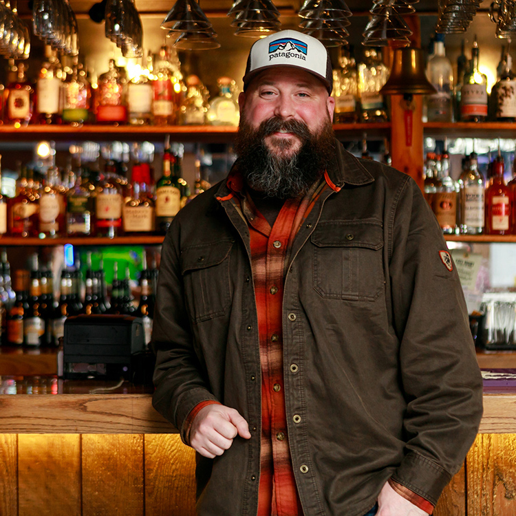 Man in front of bar shelf