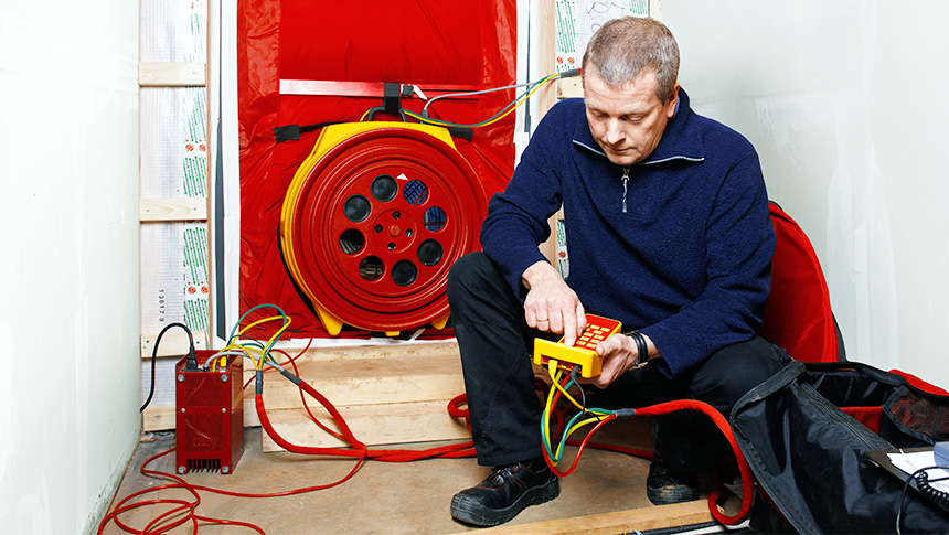 Man installing a blower door test